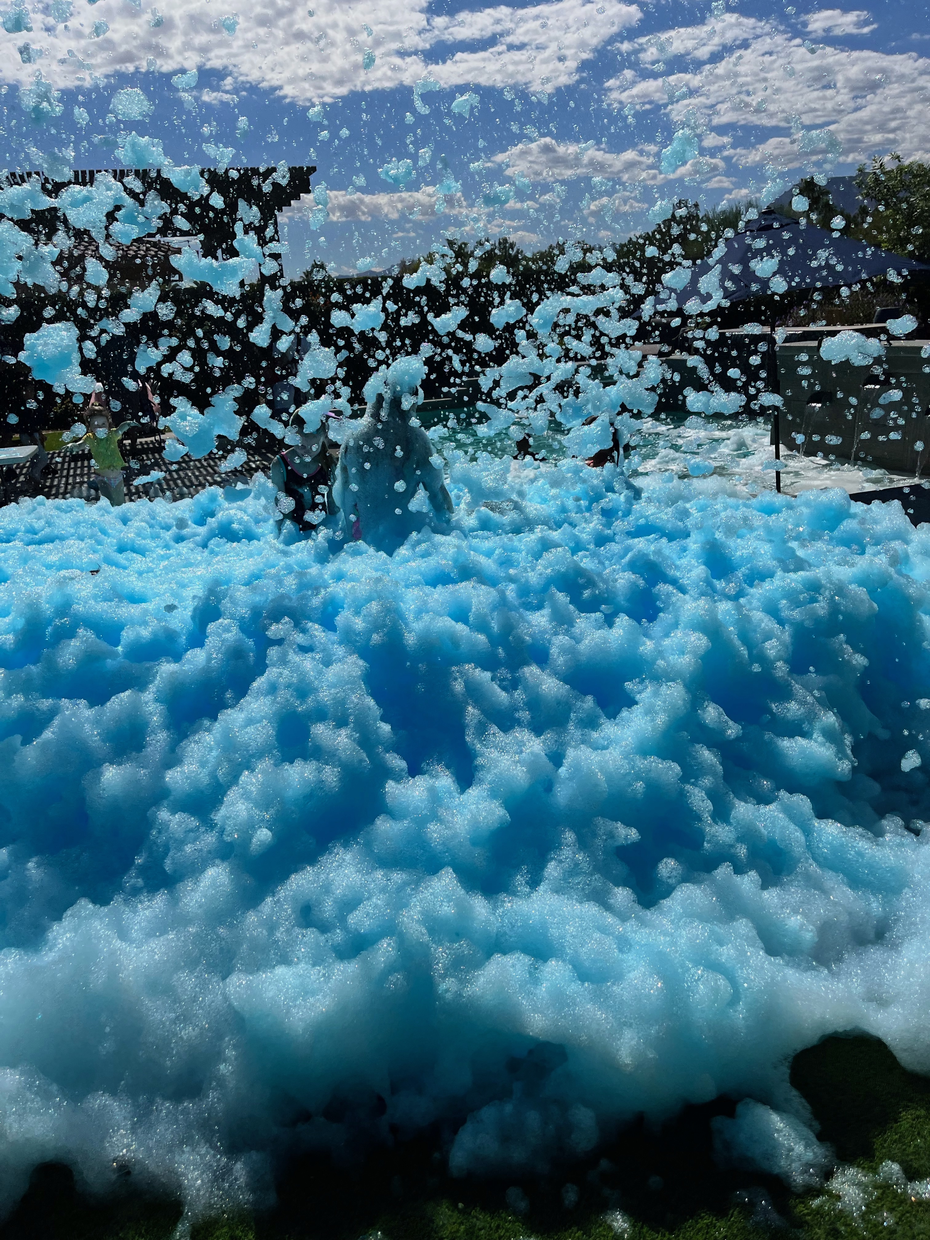 Blue foam filling an outdoor party area